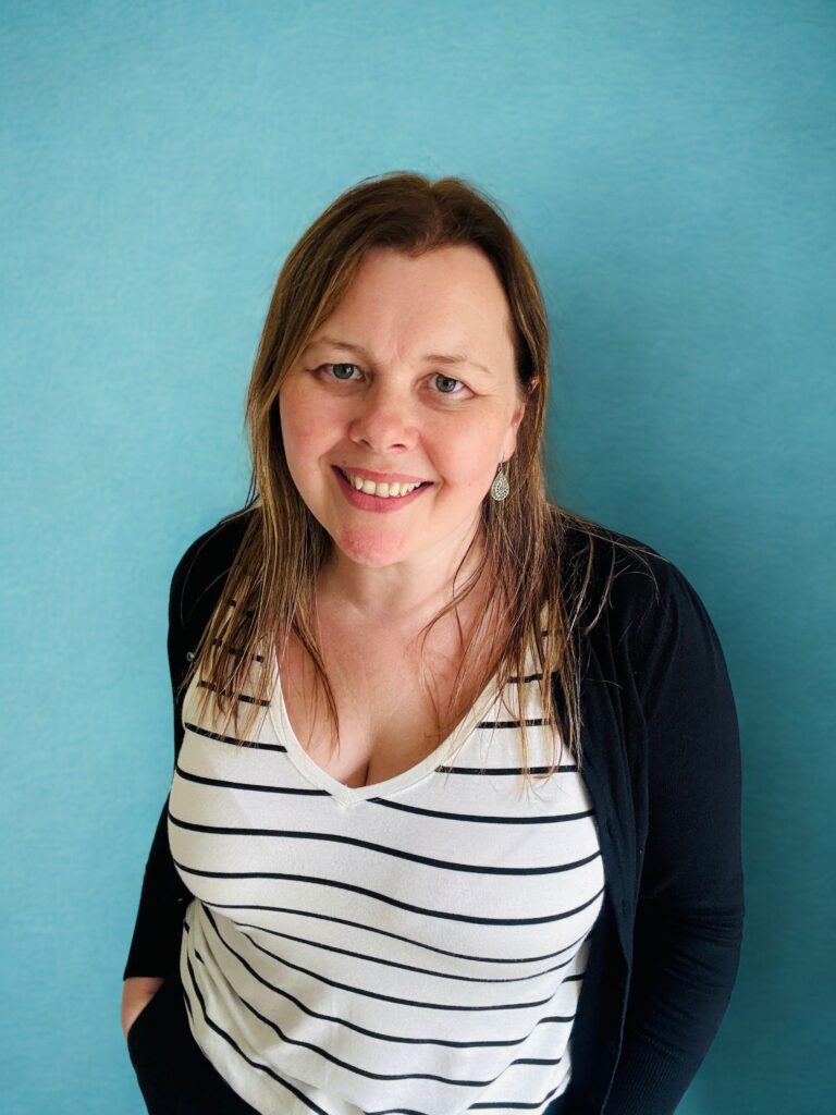 Louisa van Vessem wearing a stripy top in front of a blue background